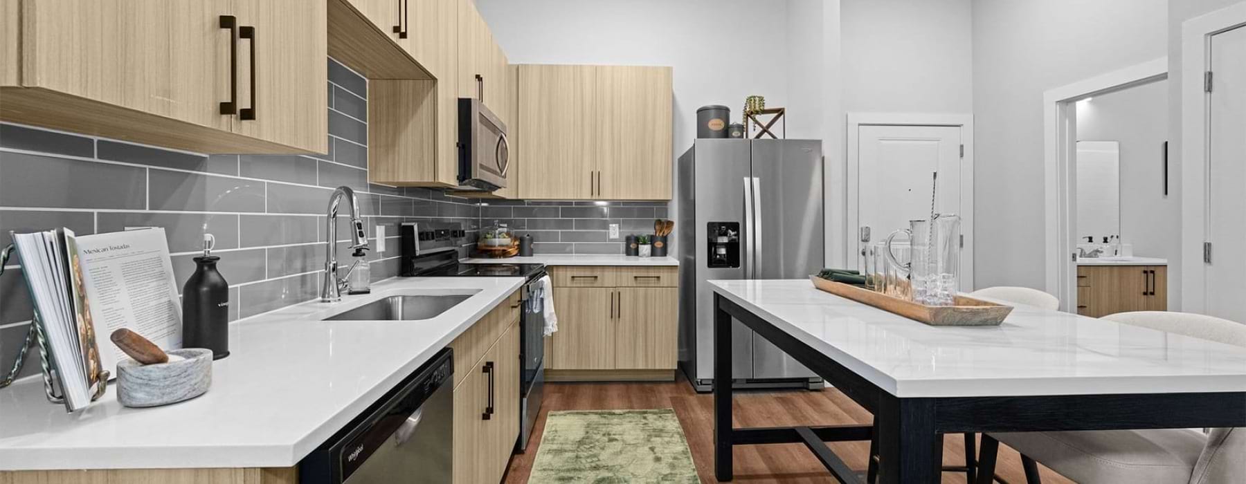 Spacious kitchen with island and stainless steel appliances in the best apartments near South End Charlotte at Charlotte Exchange.
