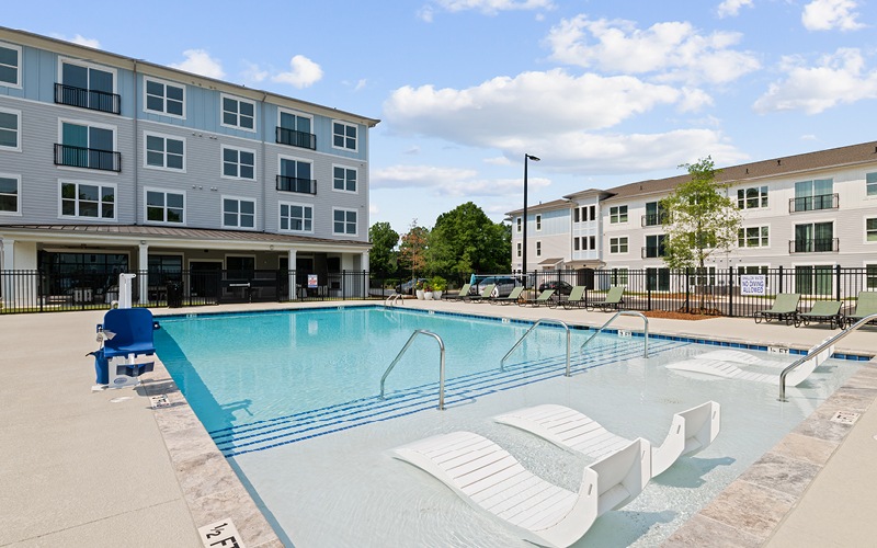Resort-style swimming pool with lounge seating