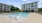 Resort-style swimming pool with lounge seating