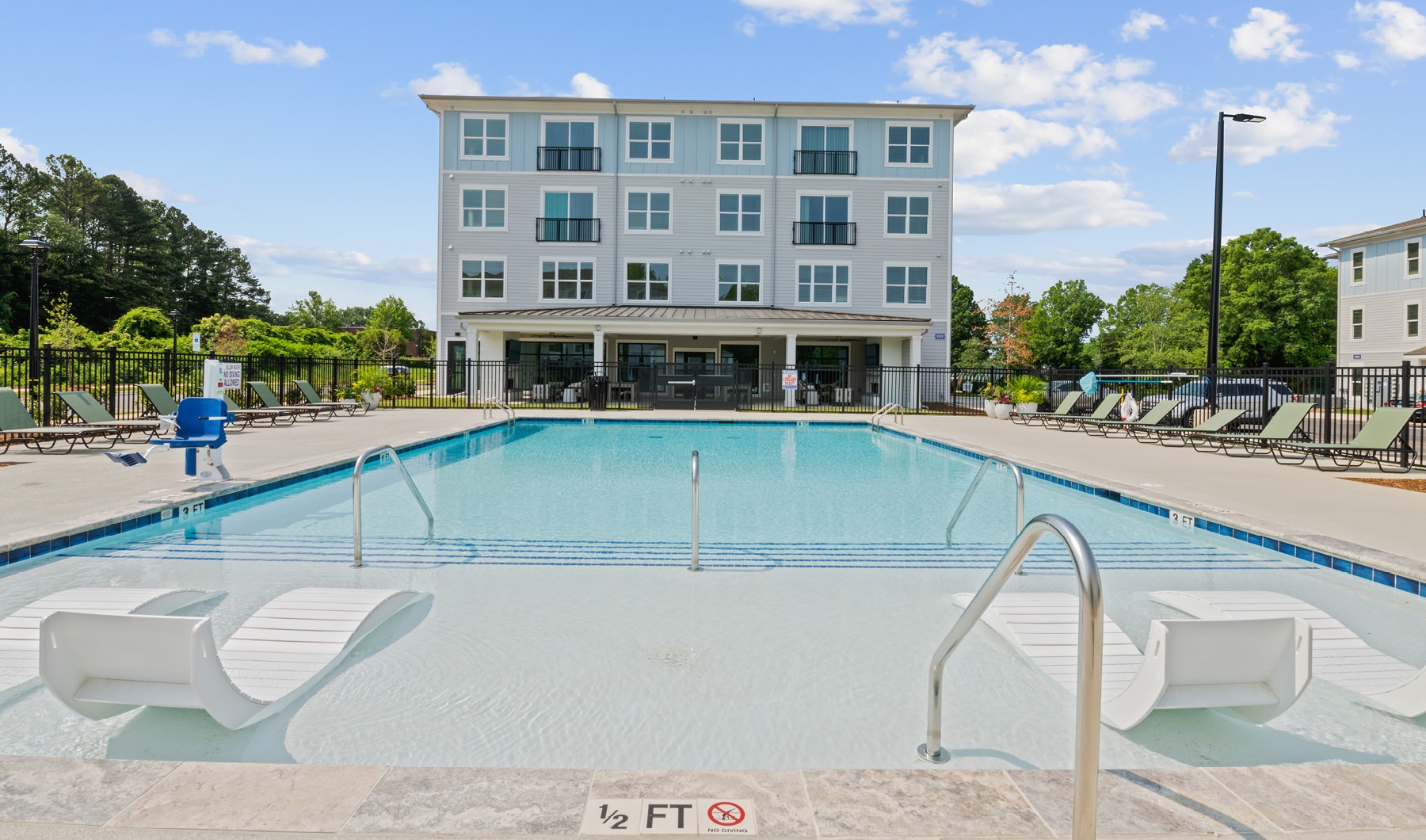 Resort-style swimming pool with lounge seating